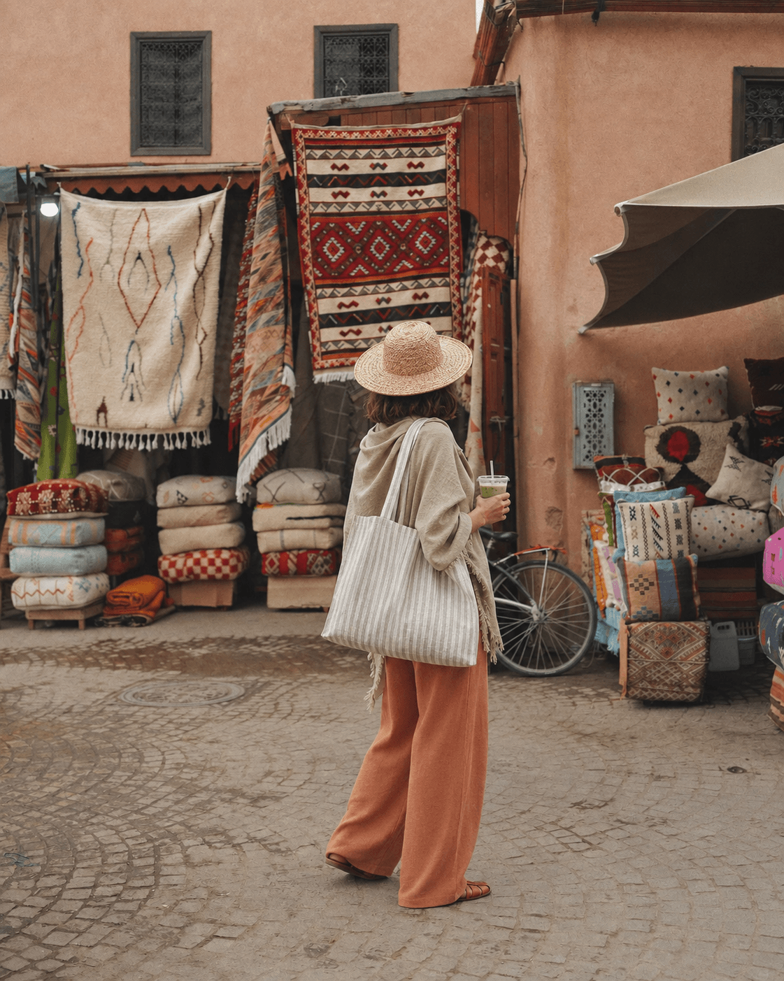 Striped tote carried through a Moroccan rug market.